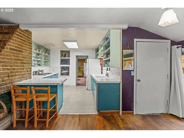 a kitchen view with granite countertop a stove and a refrigerator
