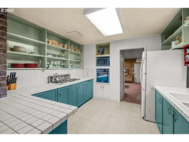 a kitchen with stainless steel appliances granite countertop a sink and cabinets