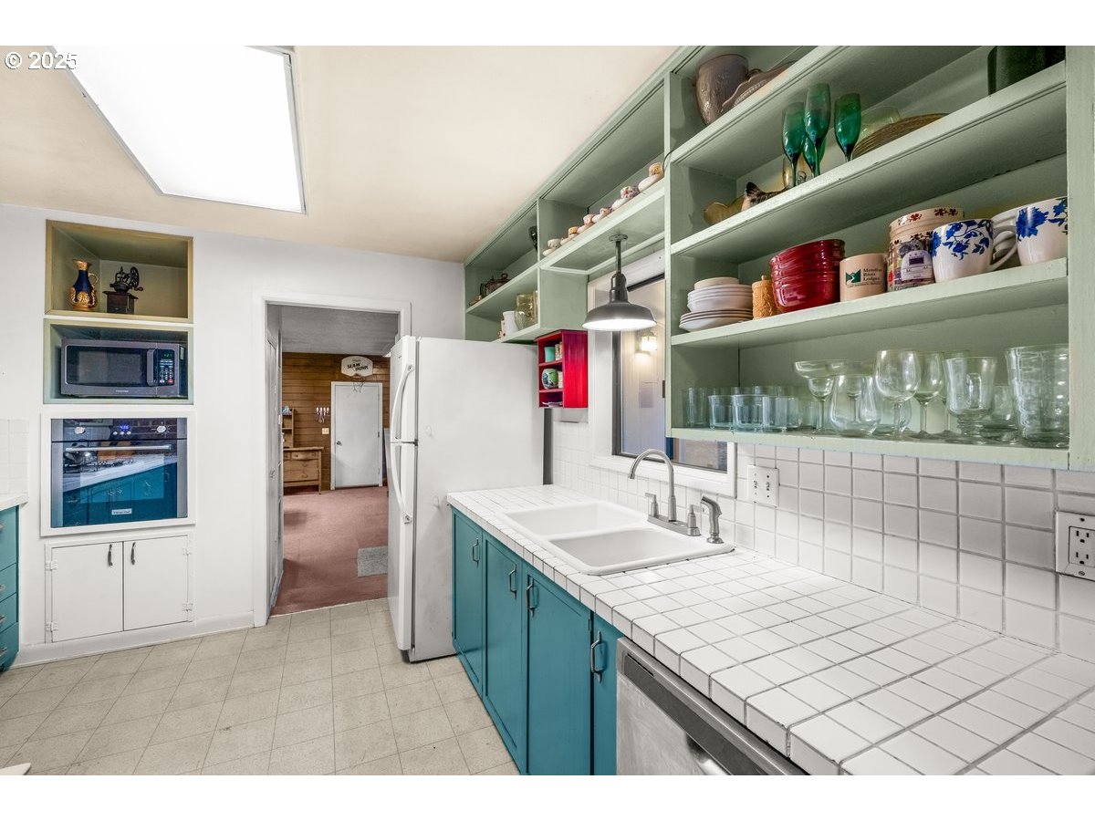 12602 Fry Road Northeast Aurora, OR 97002 - Photo 13 of 47 a kitchen with stainless steel appliances granite countertop a sink and cabinets