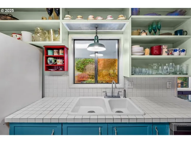 a kitchen with a sink and wooden cabinets