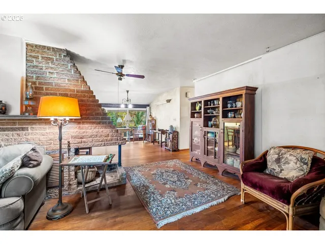 a bedroom with furniture and a large window