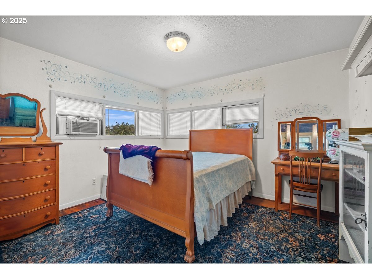 12602 Fry Road Northeast Aurora, OR 97002 - Photo 26 of 47 a bedroom with furniture and wooden floor