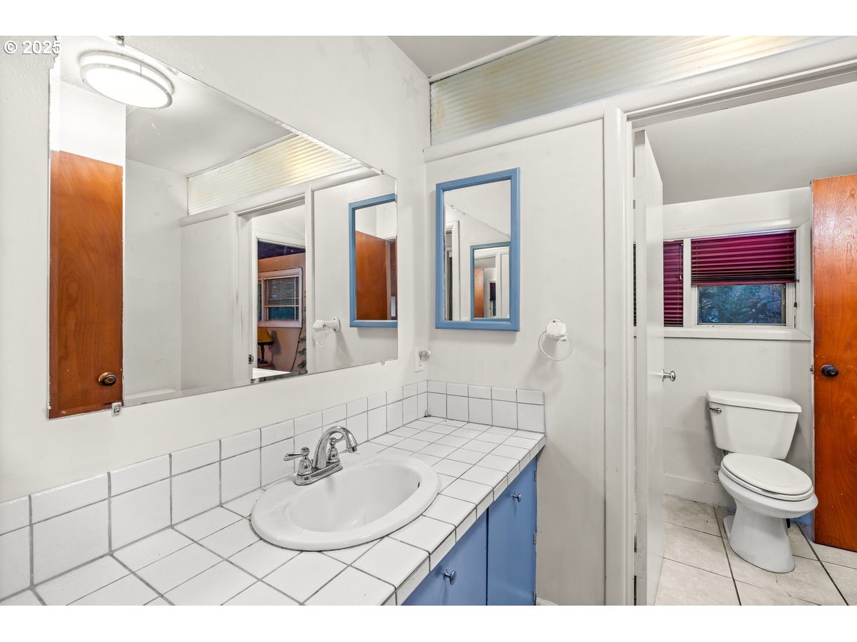 12602 Fry Road Northeast Aurora, OR 97002 - Photo 28 of 47 a bathroom with a sink vanity mirror and toilet