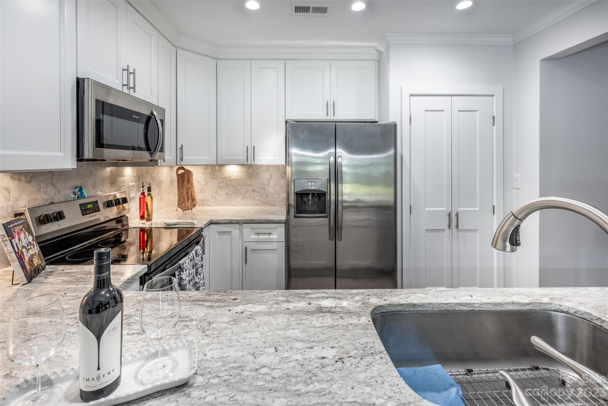 20101 Henderson Road, Unit H Cornelius, NC 28031 - Photo 14 of 48 a kitchen with stainless steel appliances granite countertop a refrigerator sink and stove