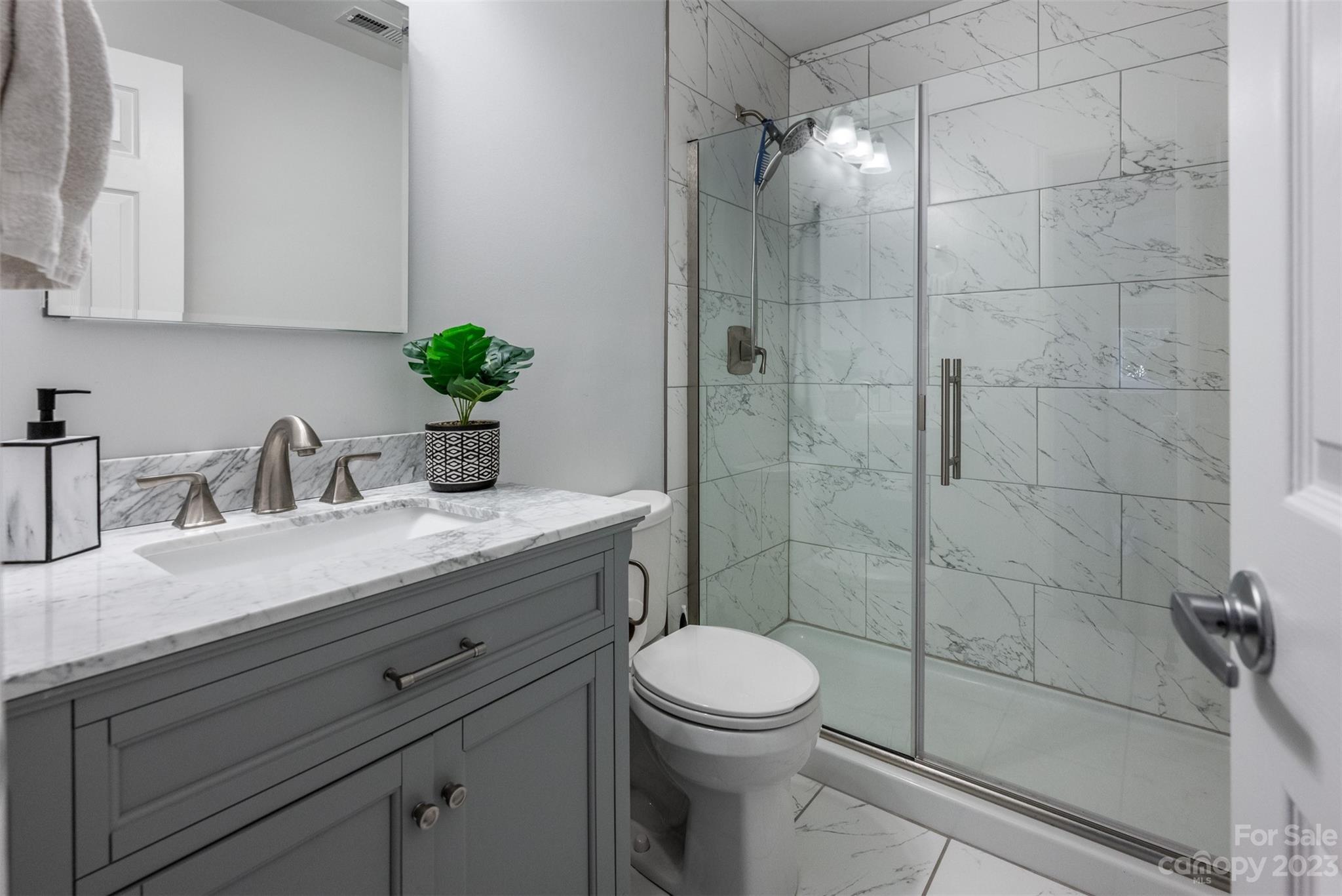 20101 Henderson Road, Unit H Cornelius, NC 28031 - Photo 18 of 48 a bathroom with a granite countertop sink a toilet and shower