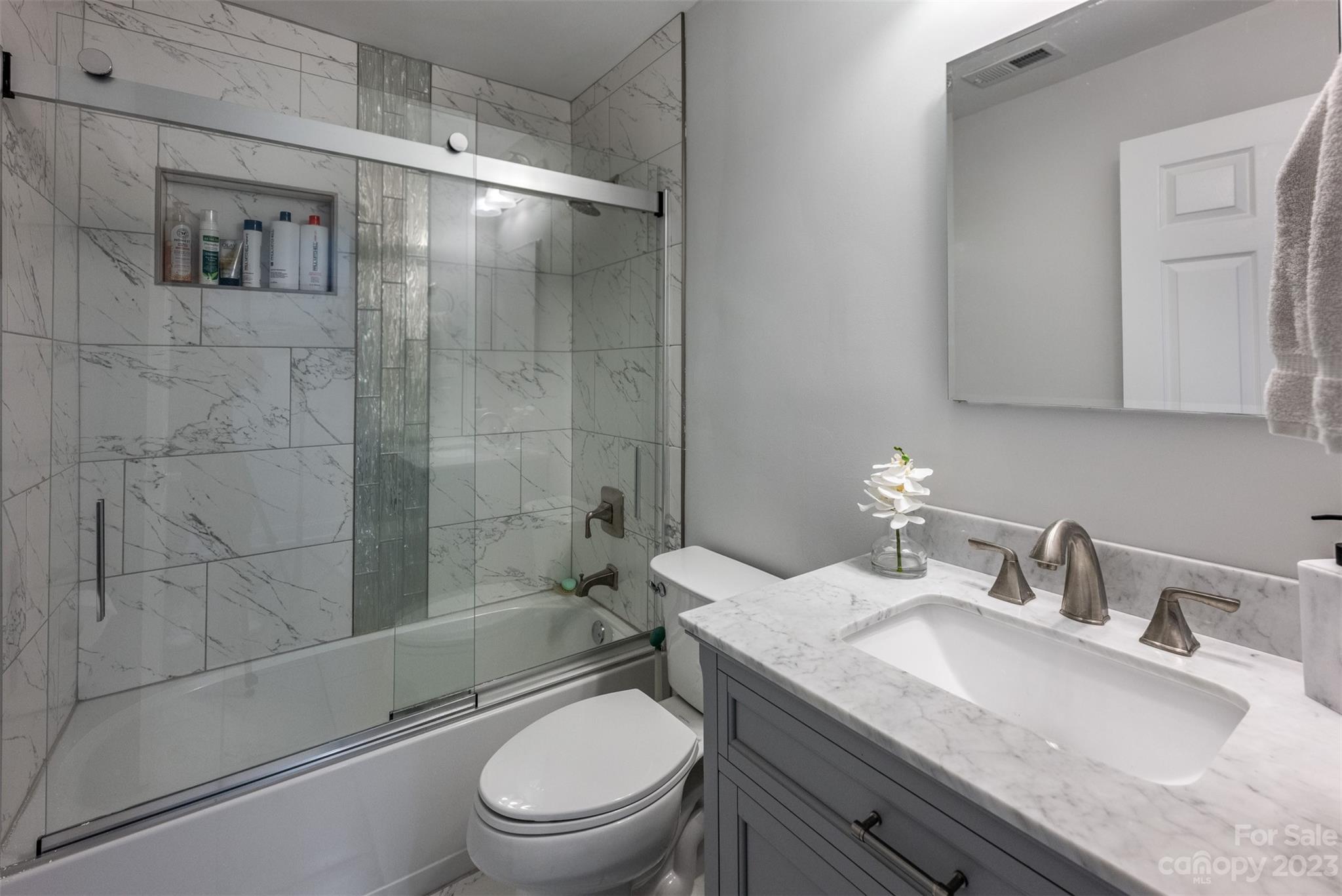 20101 Henderson Road, Unit H Cornelius, NC 28031 - Photo 20 of 48 a bathroom with a granite countertop toilet sink shower and mirror