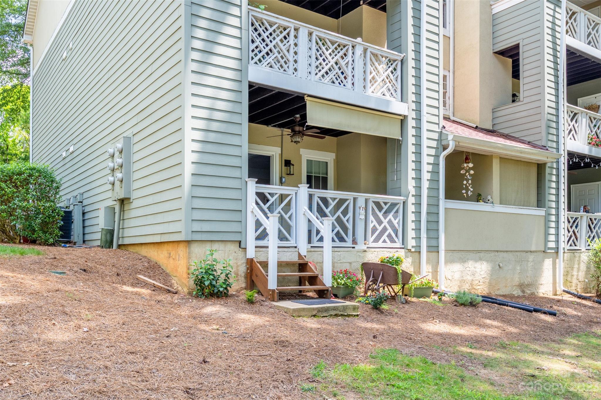 20101 Henderson Road, Unit H Cornelius, NC 28031 - Photo 28 of 48 a front view of a house with a yard and garage