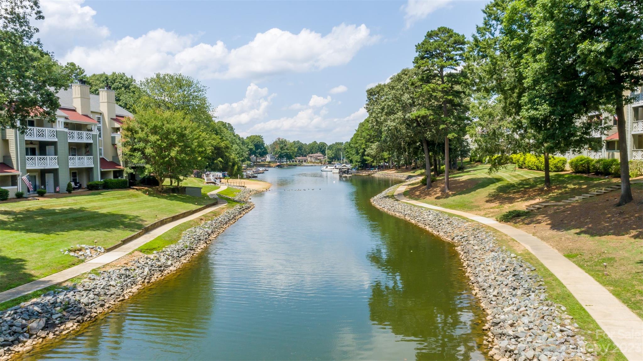 20101 Henderson Road, Unit H Cornelius, NC 28031 - Photo 45 of 48 a view of a lake with a house swimming pool and outdoor space