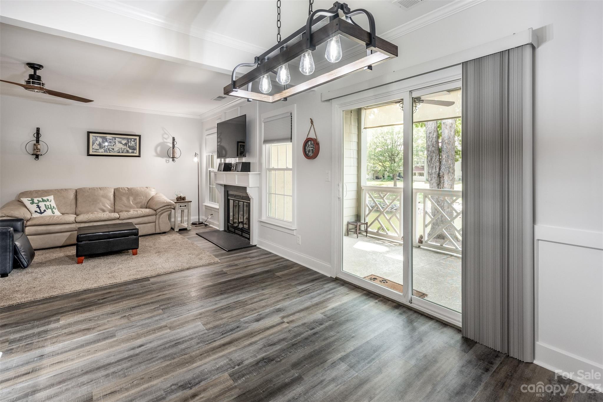 20101 Henderson Road, Unit H Cornelius, NC 28031 - Photo 8 of 48 a living room with furniture a flat screen tv and a floor to ceiling window