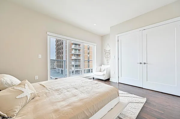 a bedroom with a large bed and a large window