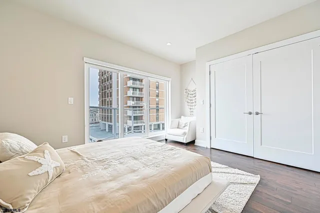 a bedroom with a large bed and a large window