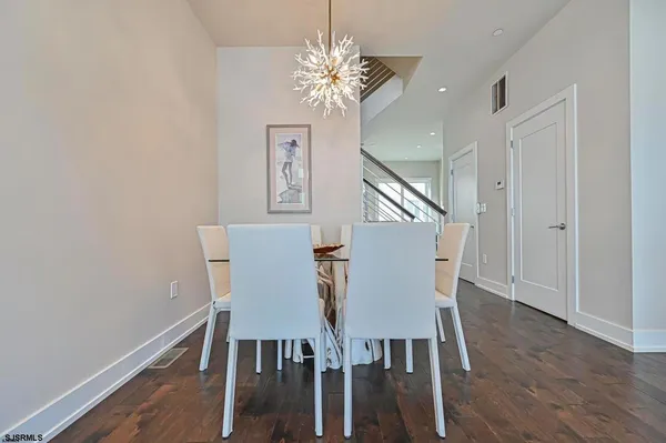 a kitchen with kitchen island white cabinets and stainless steel appliances