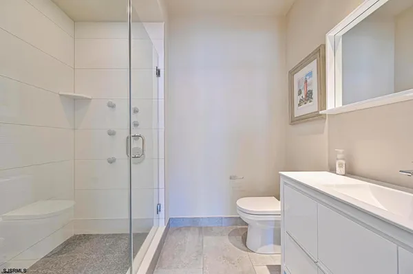 a white toilet sitting next to a bathroom sink