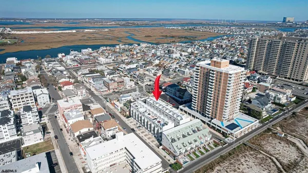 a kitchen with a dining table chairs refrigerator and cabinets