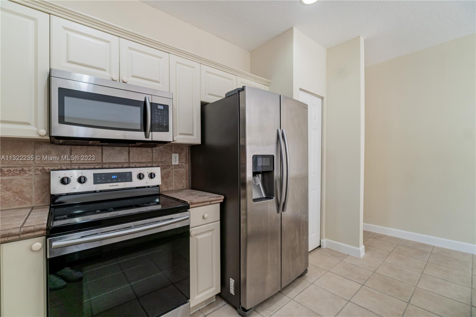 13040 Southwest 142nd Terrace Miami, FL 33186 - Photo 13 of 26 a kitchen with granite countertop a stainless steel appliances and cabinets