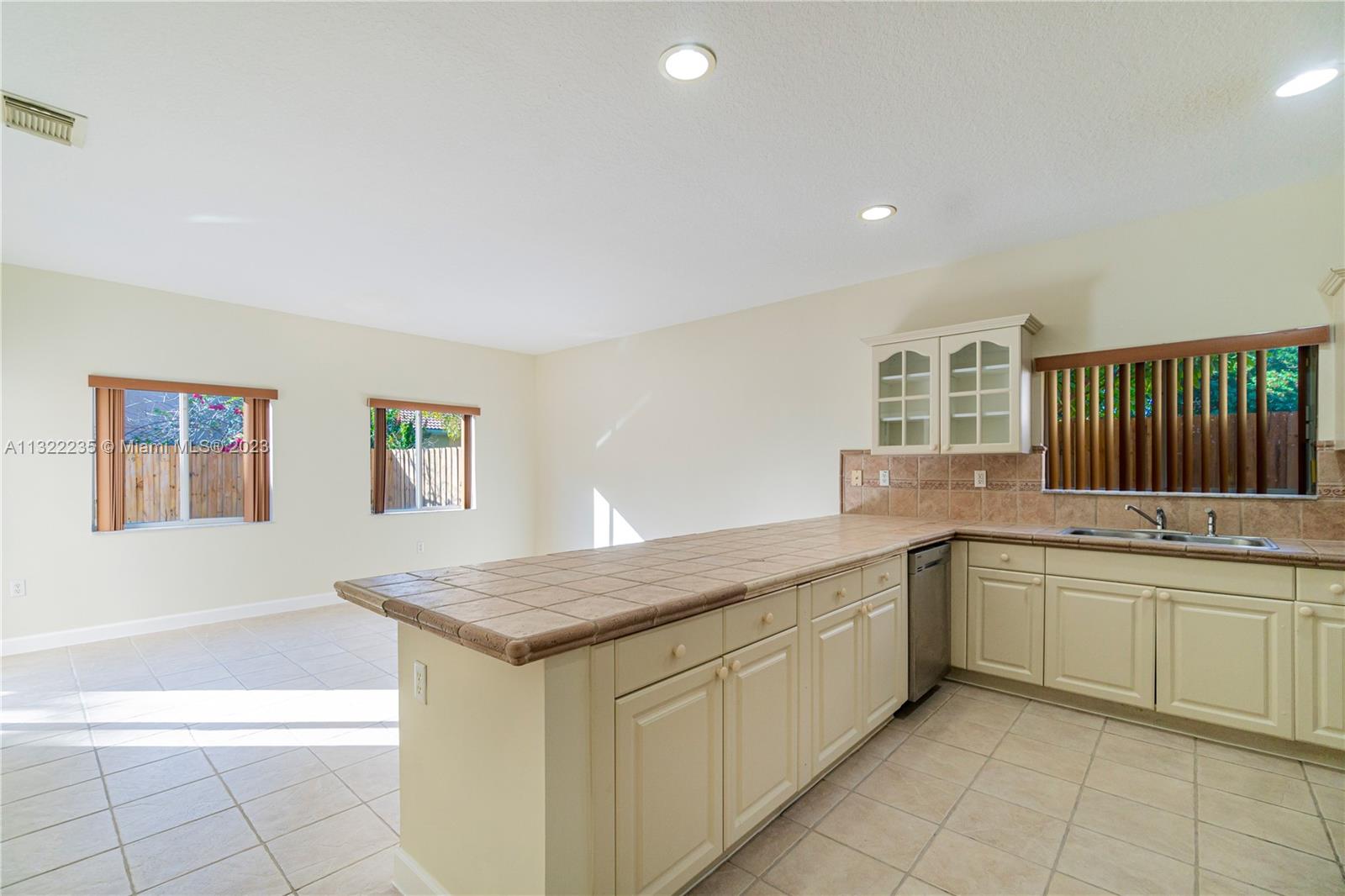 13040 Southwest 142nd Terrace Miami, FL 33186 - Photo 14 of 26 a kitchen with a sink and cabinets