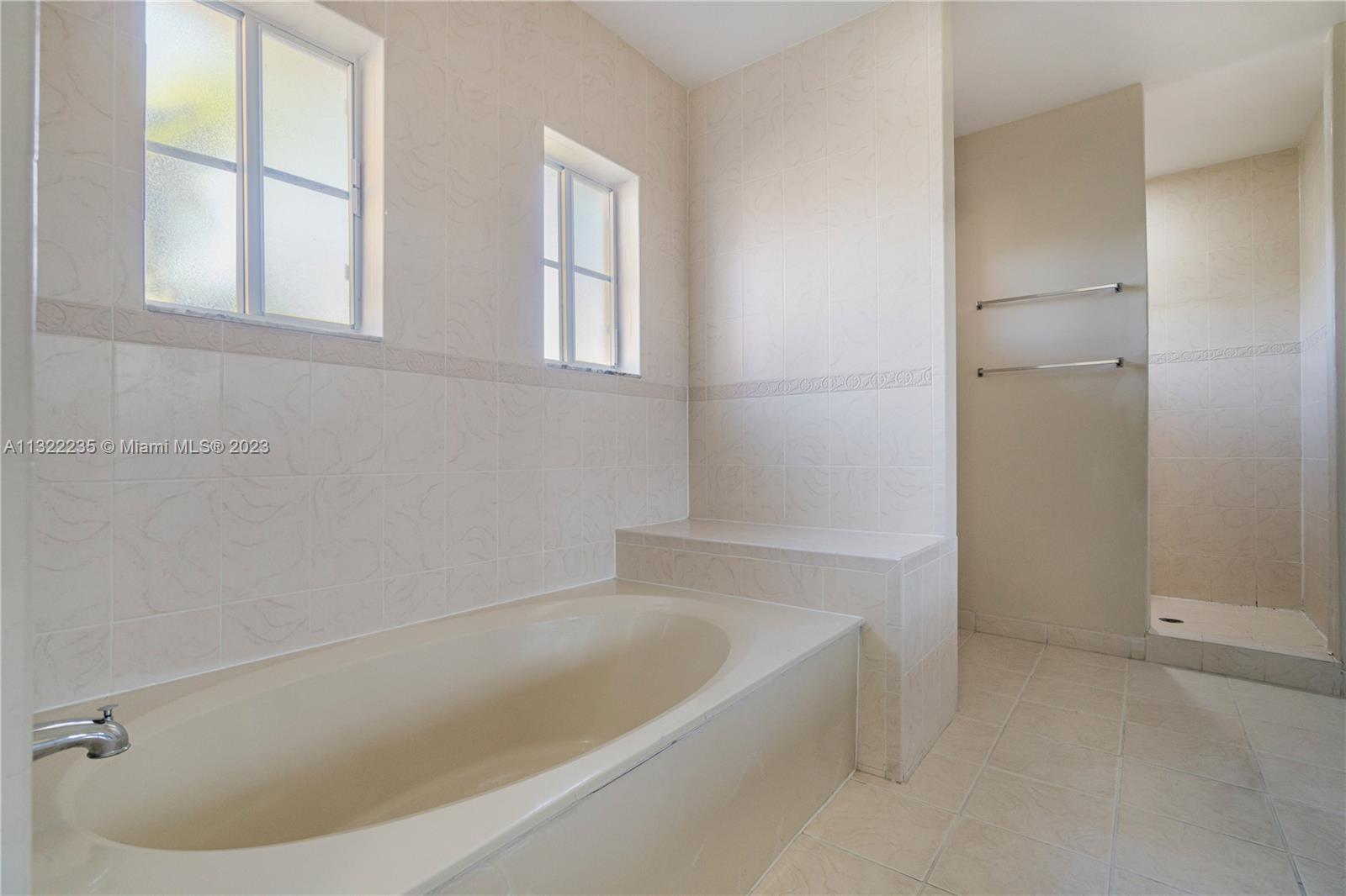 13040 Southwest 142nd Terrace Miami, FL 33186 - Photo 18 of 26 a bathroom with bathtub and window