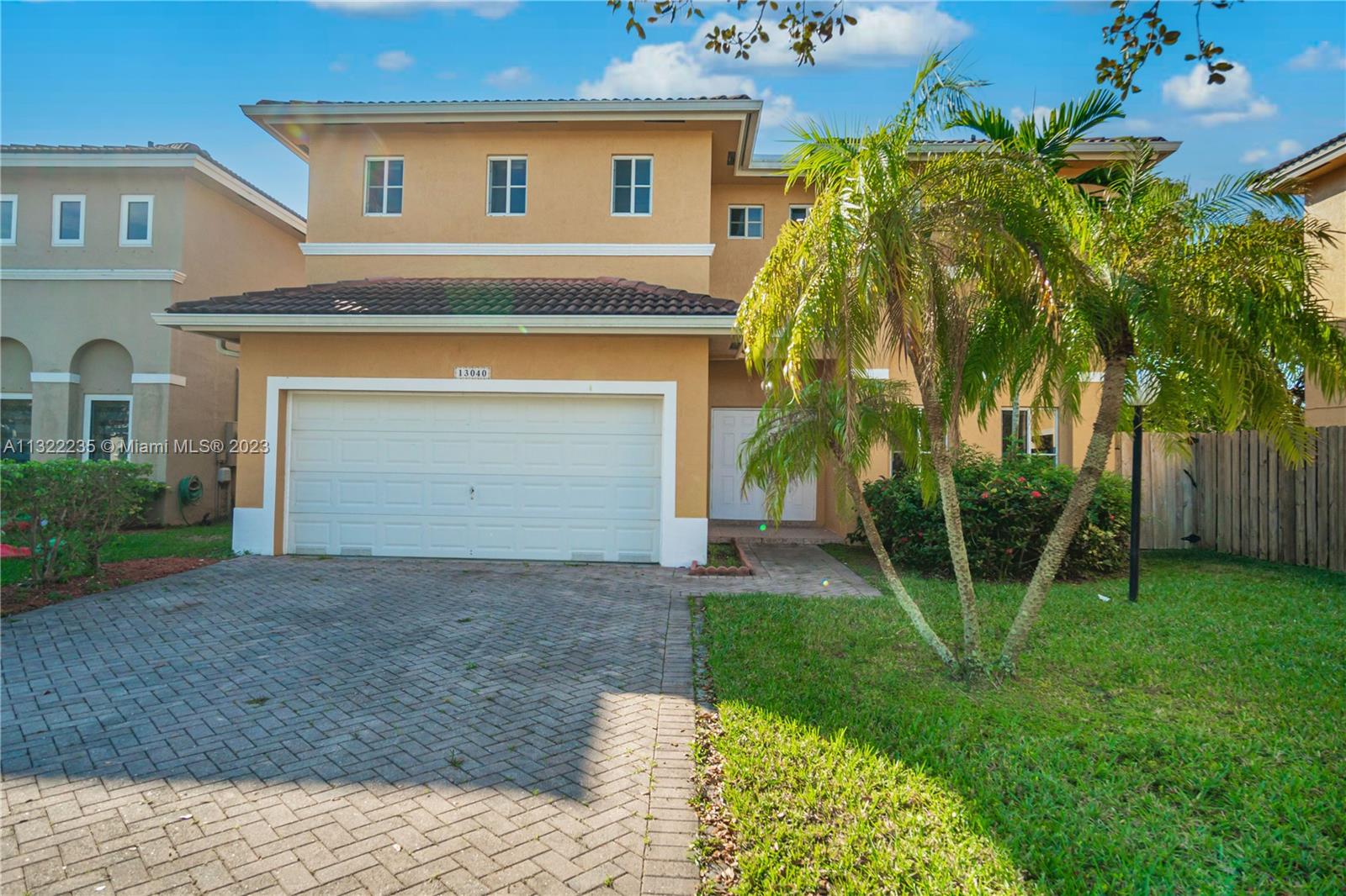 13040 Southwest 142nd Terrace Miami, FL 33186 - Photo 6 of 26 a view of a house with a yard and palm trees