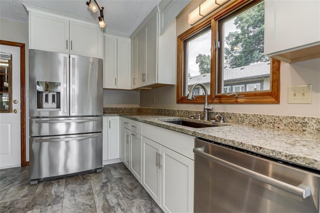 3972 Lake Shore Road South Denver, NC 28037 - Photo 13 of 48 a kitchen with stainless steel appliances granite countertop a refrigerator and a sink