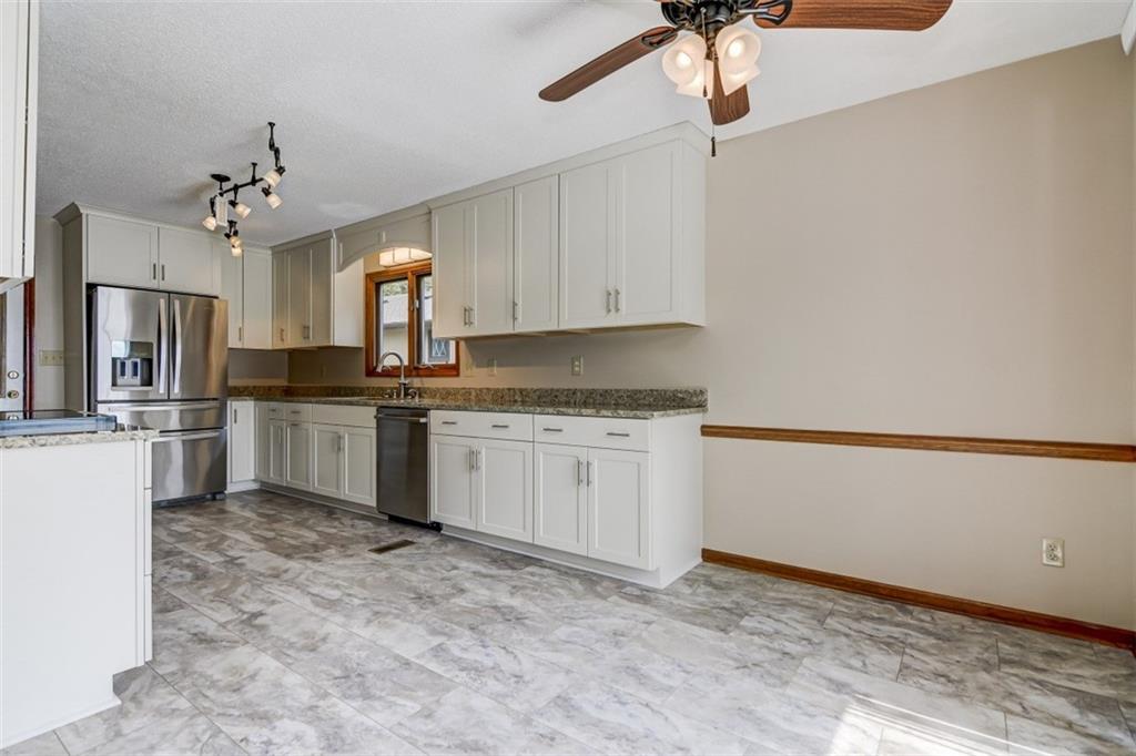 3972 Lake Shore Road South Denver, NC 28037 - Photo 15 of 48 a kitchen with granite countertop a sink cabinets stainless steel appliances and a window