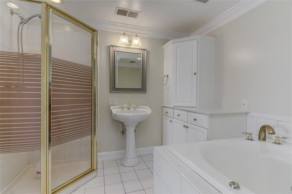 3972 Lake Shore Road South Denver, NC 28037 - Photo 24 of 48 a bathroom with a sink a toilet and shower