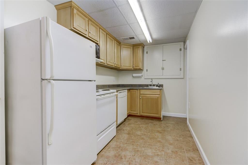 3972 Lake Shore Road South Denver, NC 28037 - Photo 27 of 48 a kitchen with white cabinets and white appliances