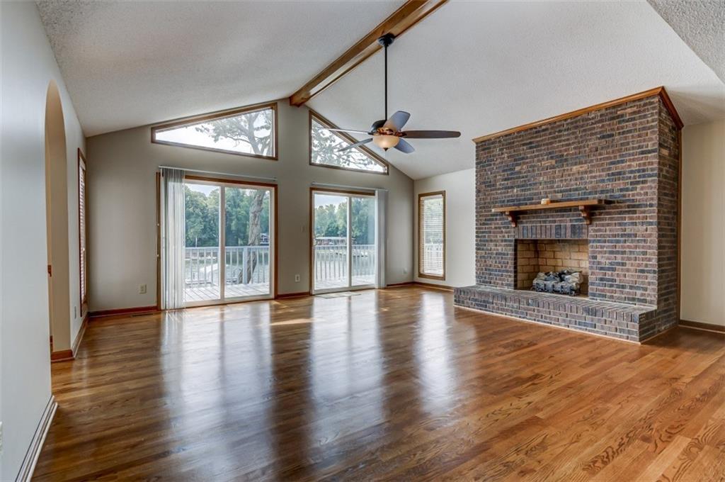 3972 Lake Shore Road South Denver, NC 28037 - Photo 33 of 48 an empty room with wooden floor fireplace and windows