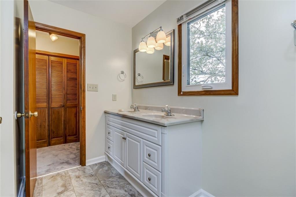 3972 Lake Shore Road South Denver, NC 28037 - Photo 38 of 48 a bathroom with a granite countertop sink and a mirror