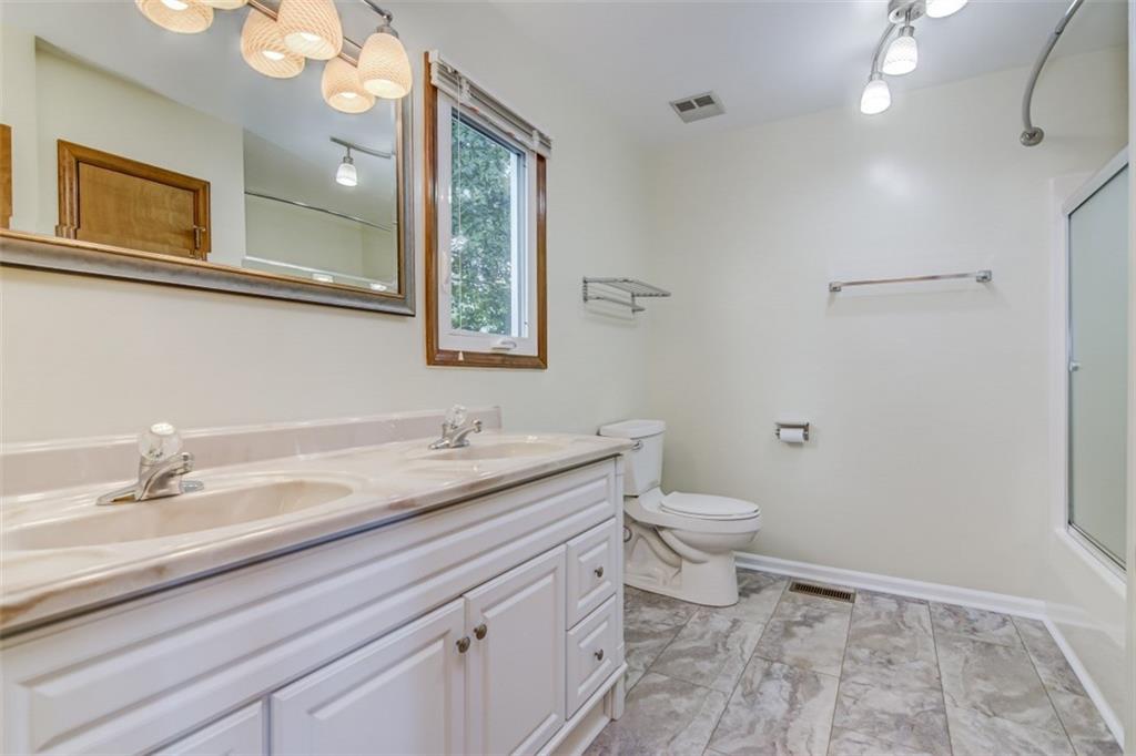 3972 Lake Shore Road South Denver, NC 28037 - Photo 39 of 48 a bathroom with a granite countertop sink a toilet and a mirror