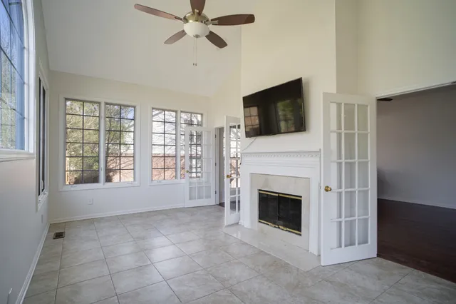 a view of an empty room with a fireplace and a window