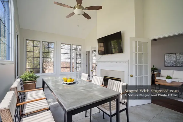 a living room with furniture a fireplace and flat screen tv