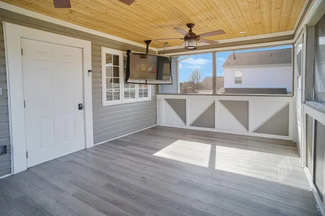 a view of a room with wooden floor and windows