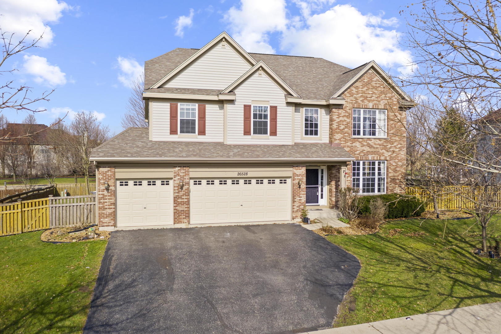 a front view of a house with a yard and garage