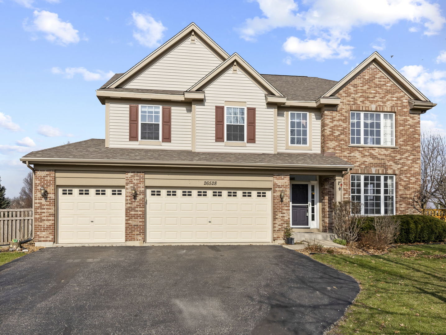 26528 Rustling Birch Way Plainfield, IL 60585 - Photo 2 of 39 a view of a white house with large windows and a yard