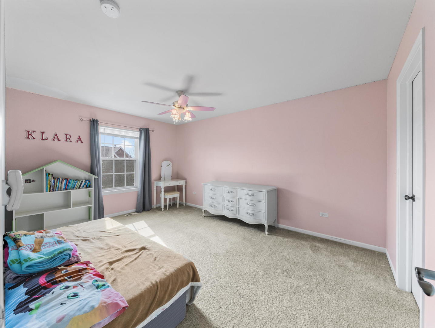 26528 Rustling Birch Way Plainfield, IL 60585 - Photo 21 of 39 a bedroom with a bed and a chandelier
