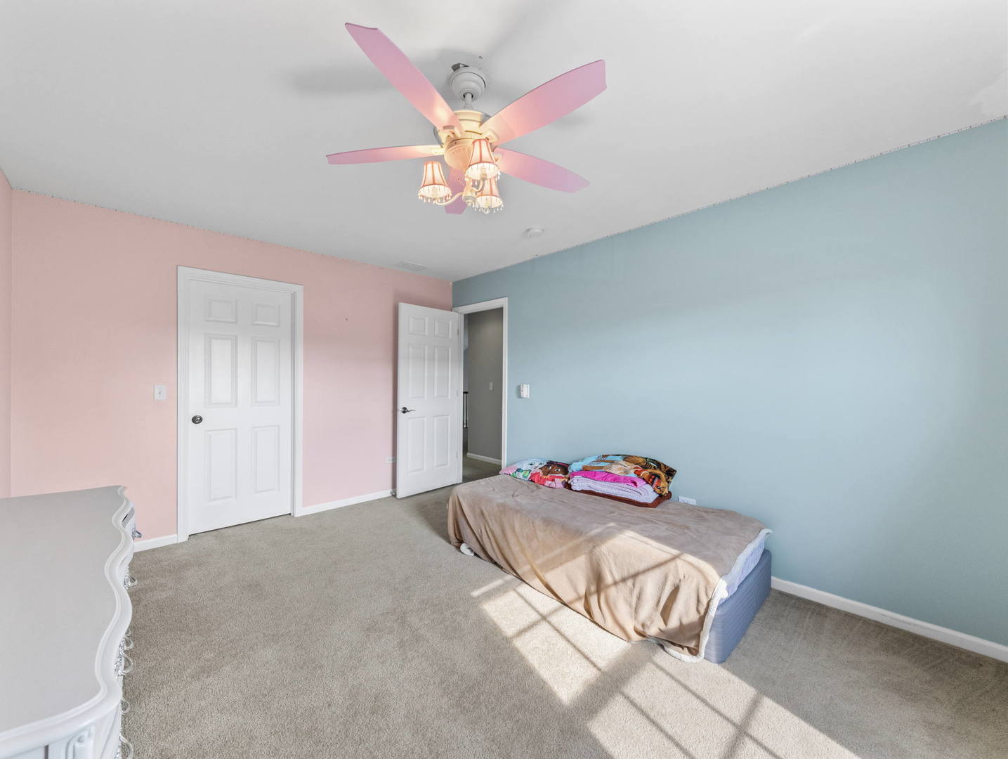 26528 Rustling Birch Way Plainfield, IL 60585 - Photo 22 of 39 a bedroom with a bed and a chandelier
