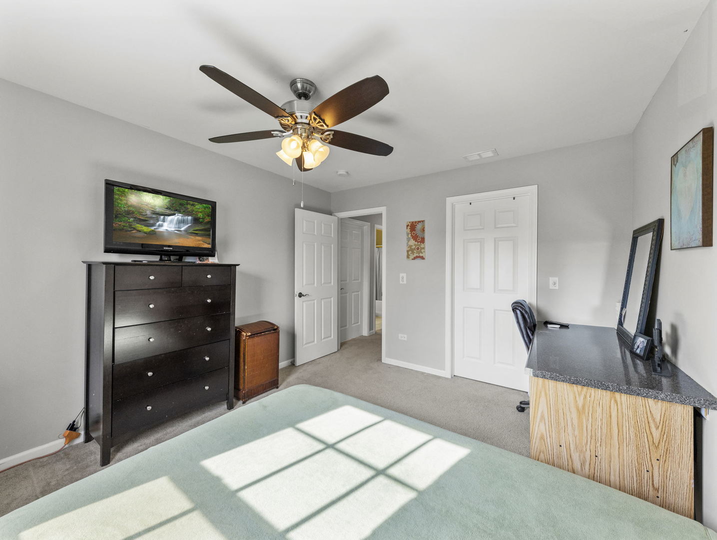 26528 Rustling Birch Way Plainfield, IL 60585 - Photo 26 of 39 a view of an empty room with a flat screen tv and dresser