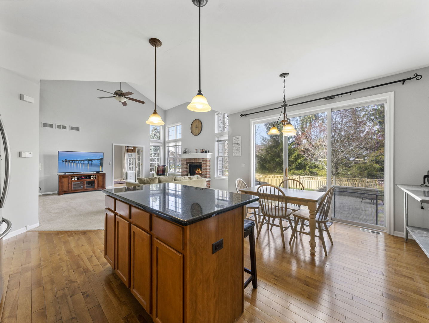 26528 Rustling Birch Way Plainfield, IL 60585 - Photo 9 of 39 a view of a dining room and livingroom with furniture wooden floor a chandelier
