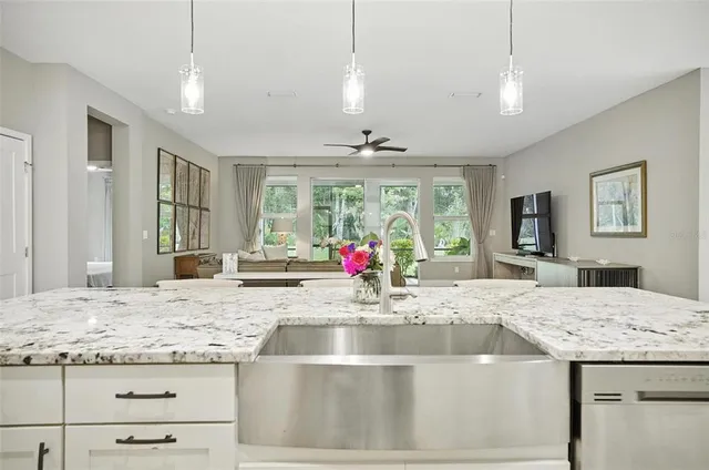 a kitchen with white cabinets and appliances