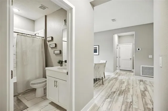 a bathroom with a shower and toilet