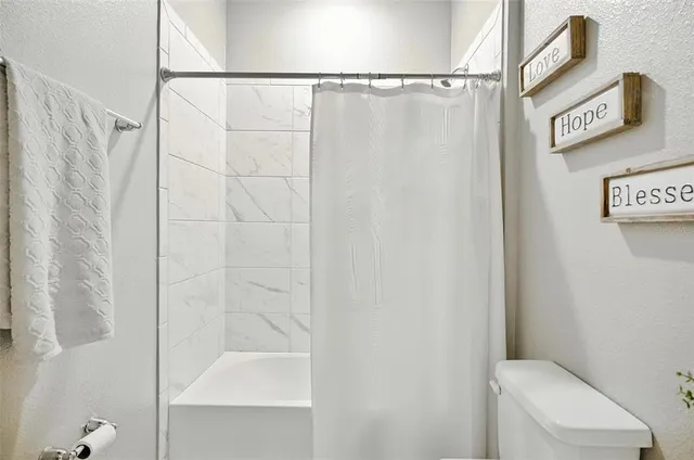 a bedroom with a large bed and a large window