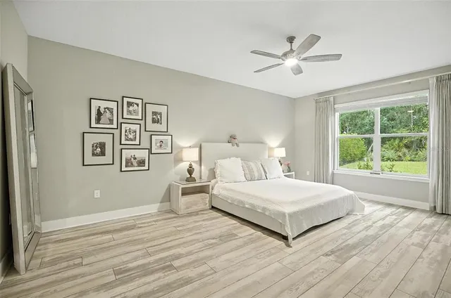 a bedroom with a bed and painting on the wall
