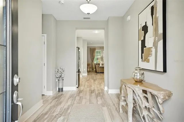 a large white kitchen with lots of counter space a sink appliances and cabinets