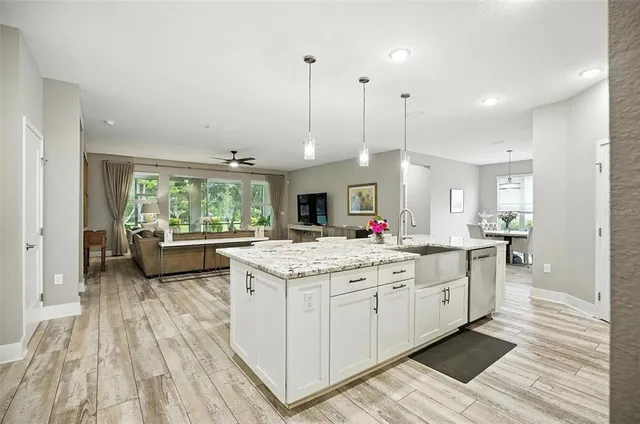 a kitchen with stainless steel appliances granite countertop wooden cabinets granite counter tops and a stove