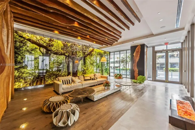 a spacious bedroom with furniture and a large window