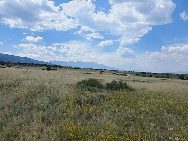 a view of a lush green hillside and an houses