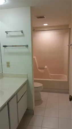 a bathroom with a shower and a toilet