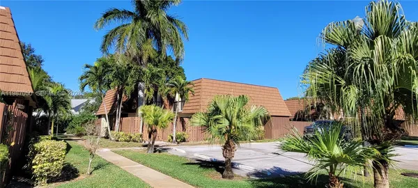 a view of a palm trees in front of a house