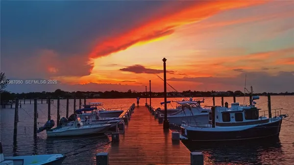 a view of a balcony with chairs and wooden floor