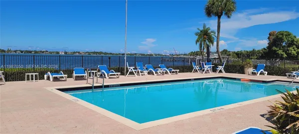 a view of a swimming pool and chairs